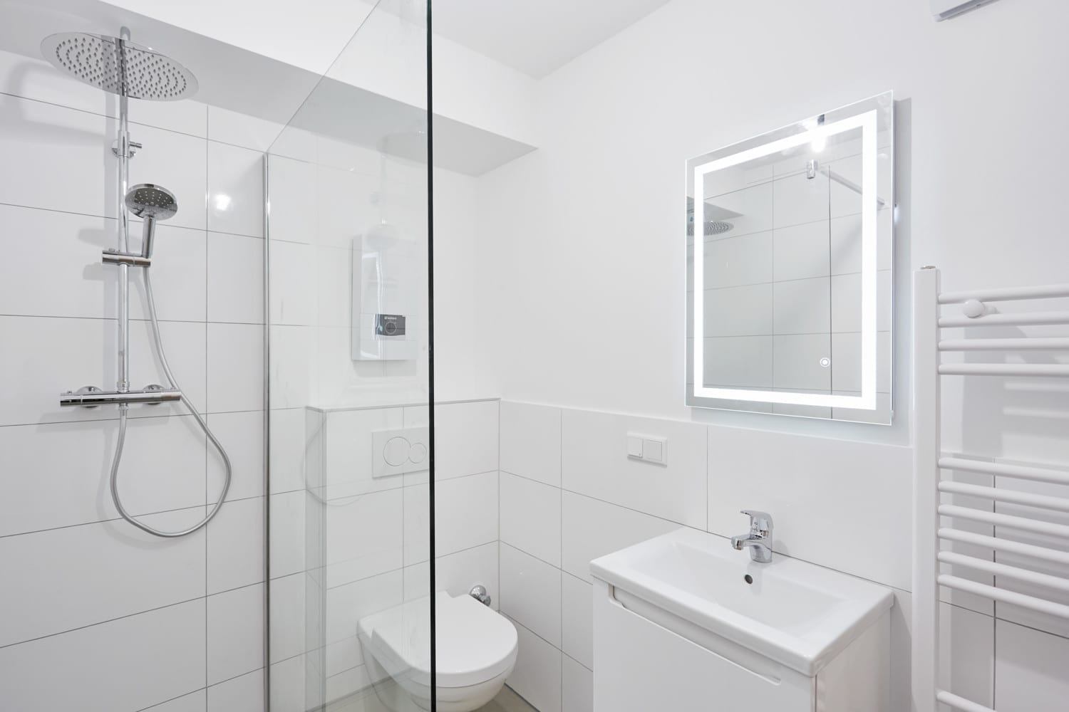 Badezimmer mit Regendusche, Waschtisch und Spiegel